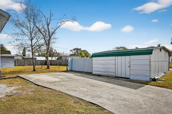 a aerial view of a house with a yard and large tree