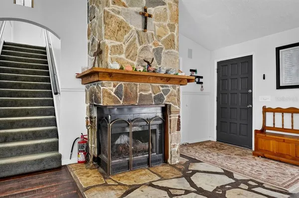 a view of a livingroom with furniture and staircase