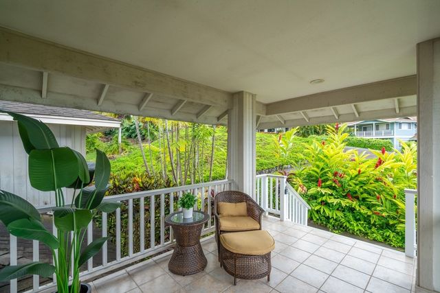 a view of a porch with furniture and garden view