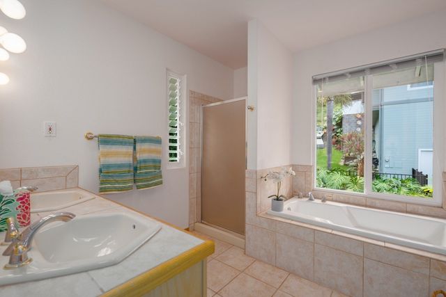 a bathroom with a tub sink and mirror