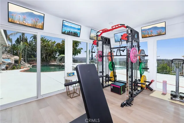 a room with pool table and windows