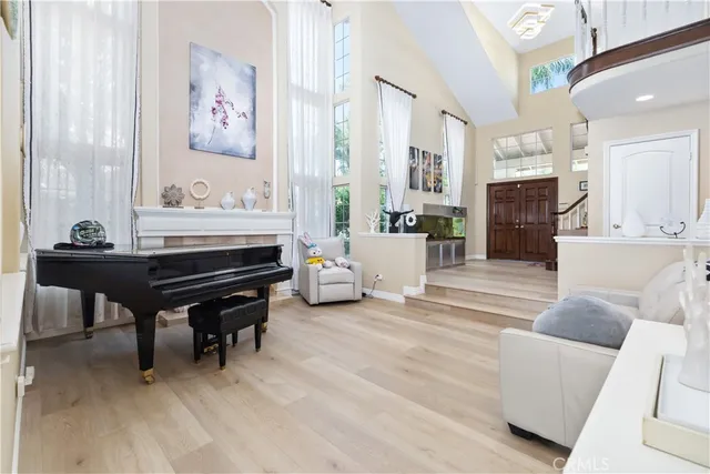 a living room with furniture and a piano table