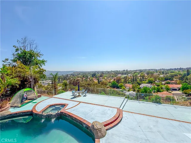 a front view of house with outdoor space and swimming pool