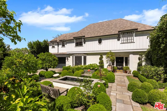 a aerial view of a house with swimming pool and sitting area