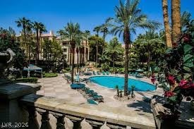 260 East Flamingo Road, Unit 220 Las Vegas, NV 89169 - Photo 23 of 32 A pristine pool with ample lounge seating awaits in this luxurious resort-style setting.