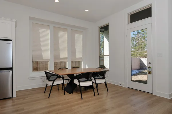 a view of a dining room with furniture and window