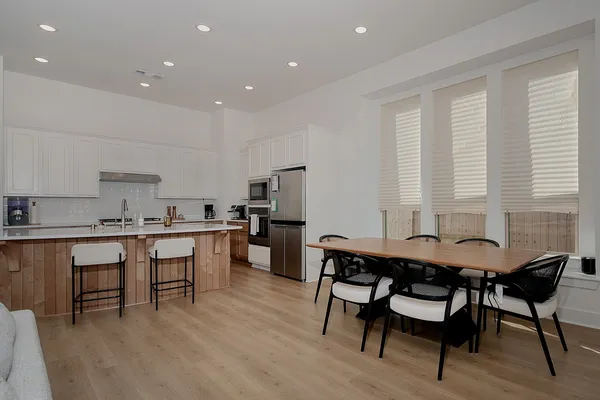 a view of a dining room with furniture and wooden floor