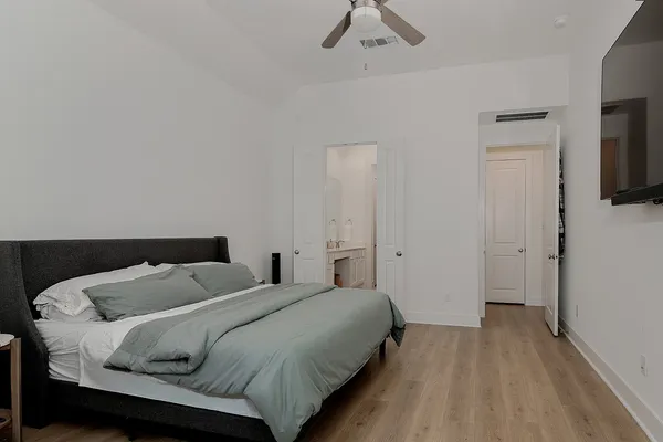a bedroom with a bed and a flat screen tv