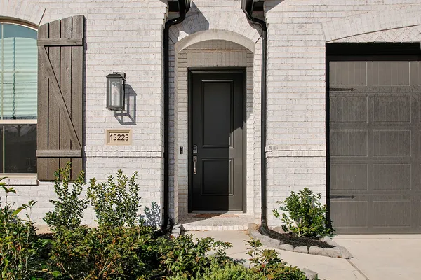 a front view of a house with a garden