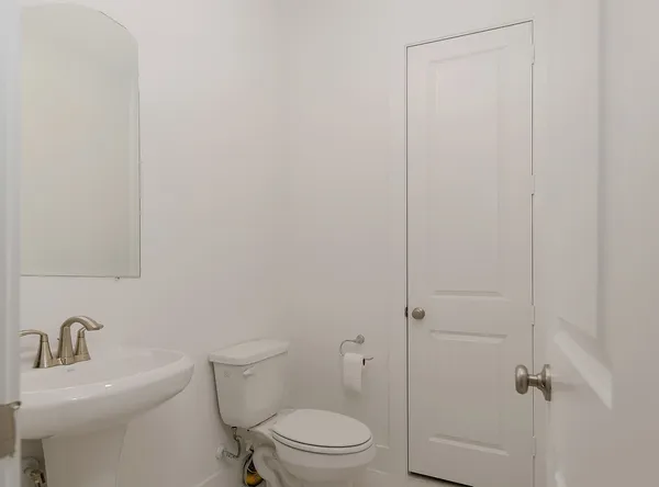 a white toilet sitting next to a bathroom sink