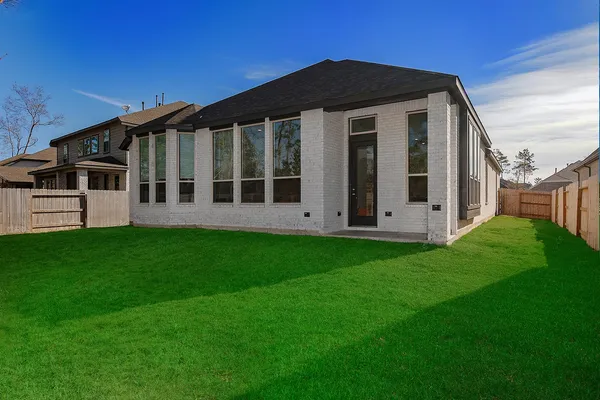 a view of a house with yard and sitting area