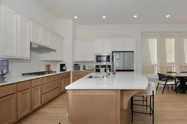a kitchen with stainless steel appliances granite countertop a sink counter space and cabinets