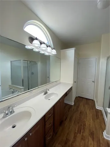 a bathroom with a double vanity sink and a mirror