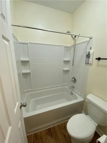 a bathroom with a toilet and a bathtub