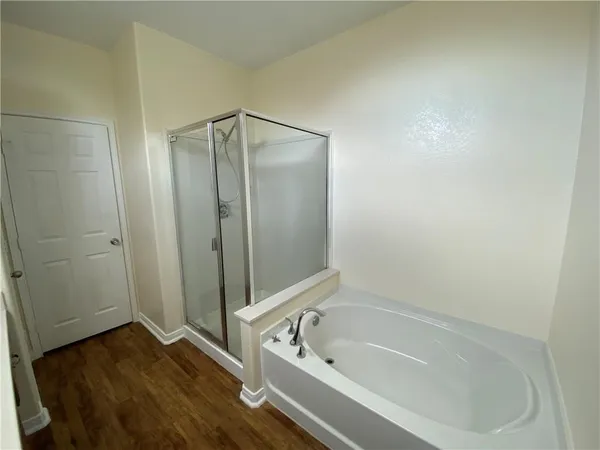 a bathroom with a tub and shower