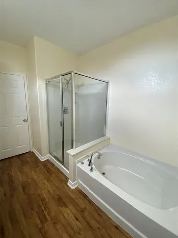 a bathroom with a bathtub and a shower