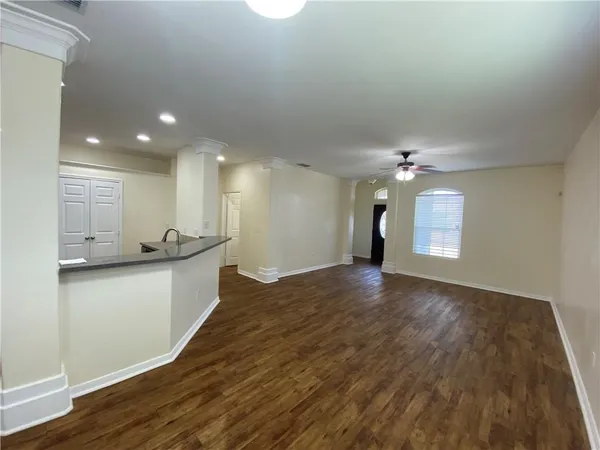 a view of a kitchen with a sink and wooden floor