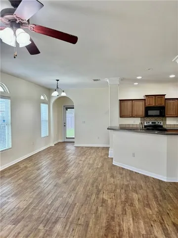 a view of a kitchen with a sink and a stove top oven