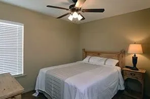 a bedroom with a bed and a lamp