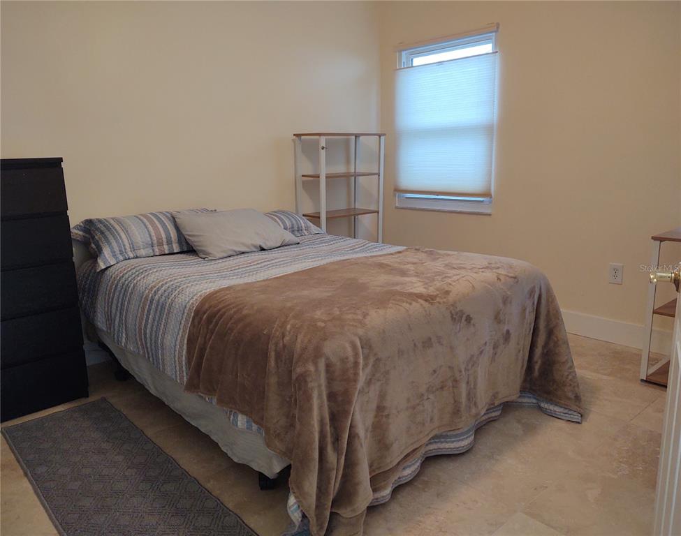 10906 West Cove Harbor Drive, Unit 10906 Crystal River, FL 34428 - Photo 11 of 15 a bed sitting in a bedroom next to a window