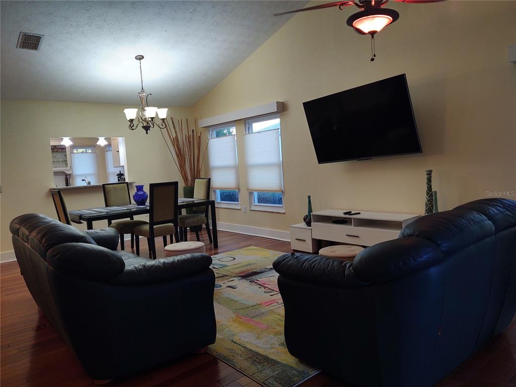 10906 West Cove Harbor Drive, Unit 10906 Crystal River, FL 34428 - Photo 3 of 15 a living room with furniture and a flat screen tv