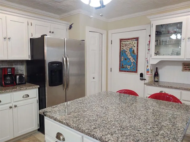 a kitchen with stainless steel appliances kitchen island a refrigerator sink and stove