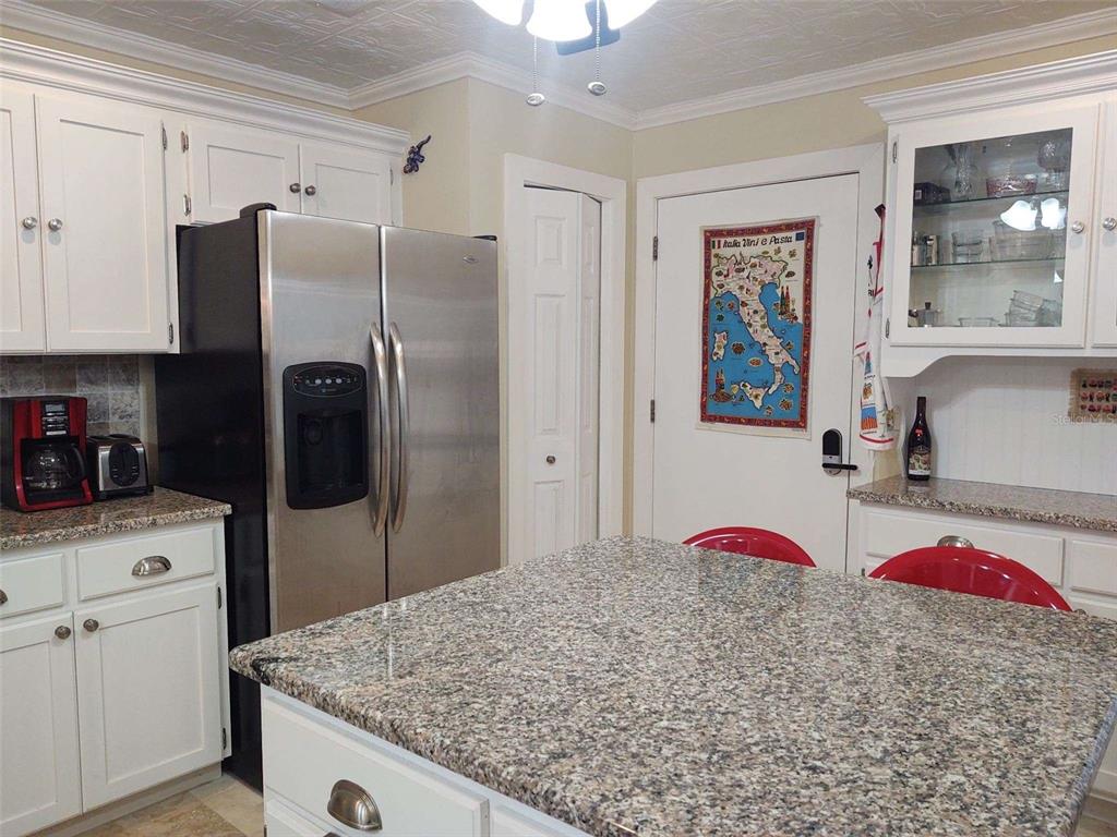 10906 West Cove Harbor Drive, Unit 10906 Crystal River, FL 34428 - Photo 7 of 15 a kitchen with stainless steel appliances kitchen island a refrigerator sink and stove