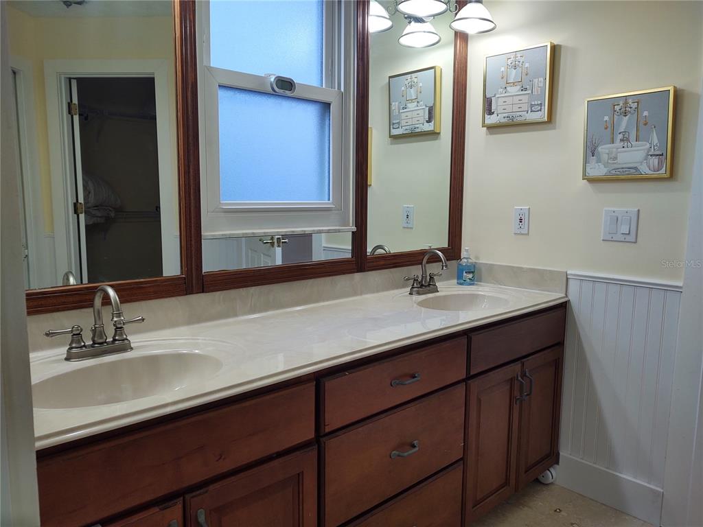 10906 West Cove Harbor Drive, Unit 10906 Crystal River, FL 34428 - Photo 9 of 15 a bathroom with a sink double vanity and a mirror