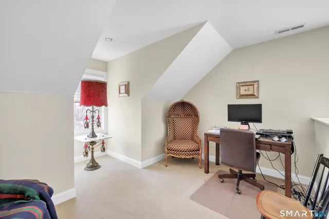 a view of a workspace with furniture and a workspace