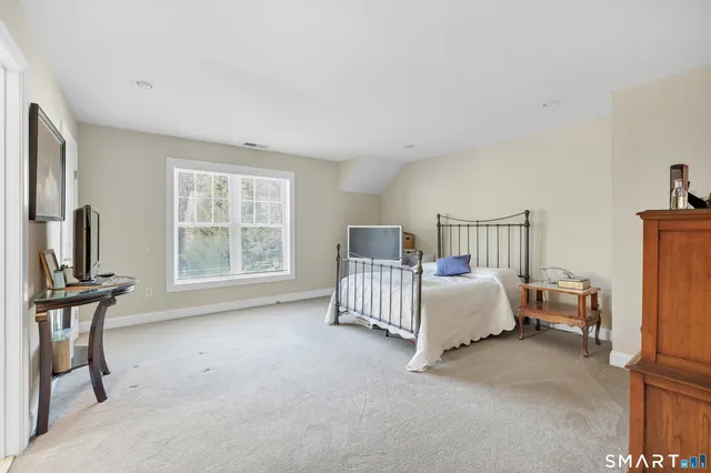 a bed room with furniture and window