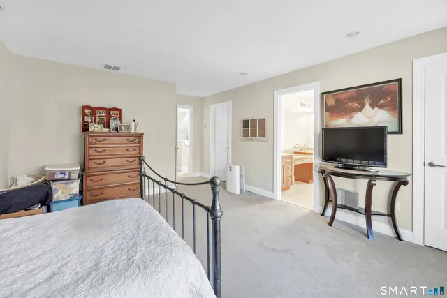 a bedroom with furniture and a flat screen tv