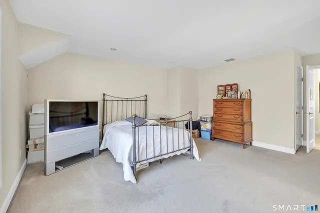 a bedroom with a bed and a couch