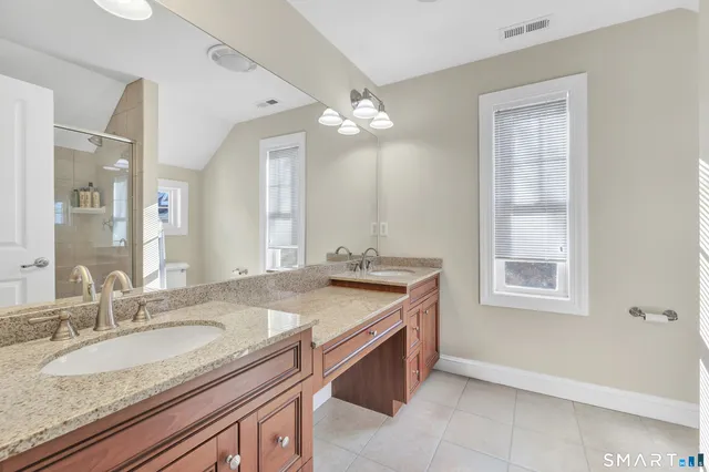 a bathroom with a granite countertop sink a large mirror and a