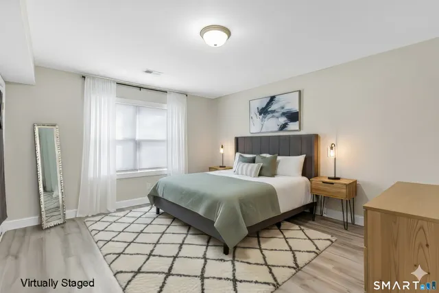 a bedroom with a bed and a window