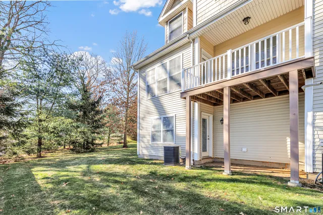 a view of a house with a yard and sitting area
