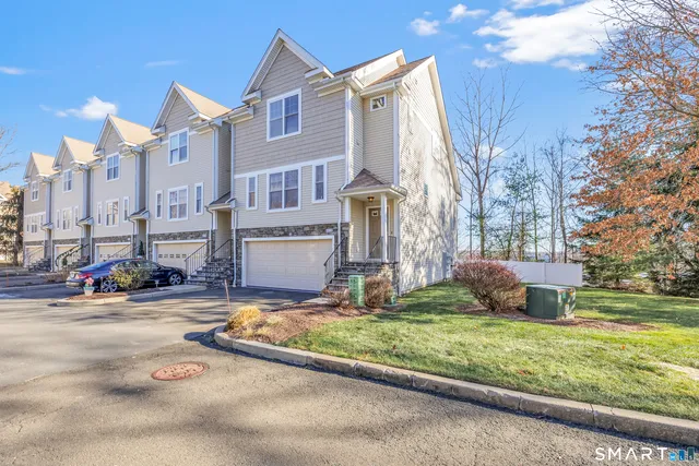 a view of a street with cars parked