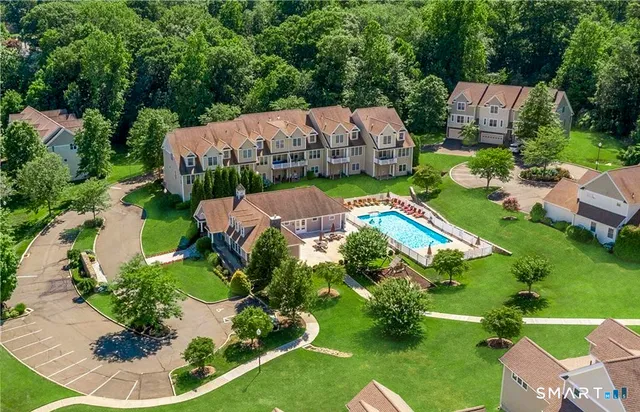 an aerial view of a house with yard swimming pool and outdoor seating