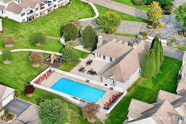 an aerial view of a house with outdoor space pool seating area and yard