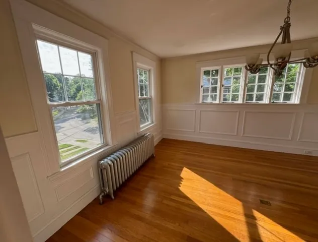 a view of wooden floor and windows in the room