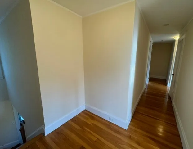 a view of room with window and hardwood floor
