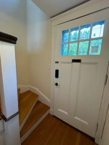 a view of bedroom with a bed and wooden floor