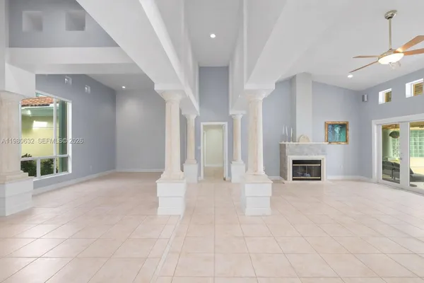 a living room with furniture a fireplace and a chandelier