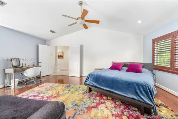 a bedroom with a large bed and a window