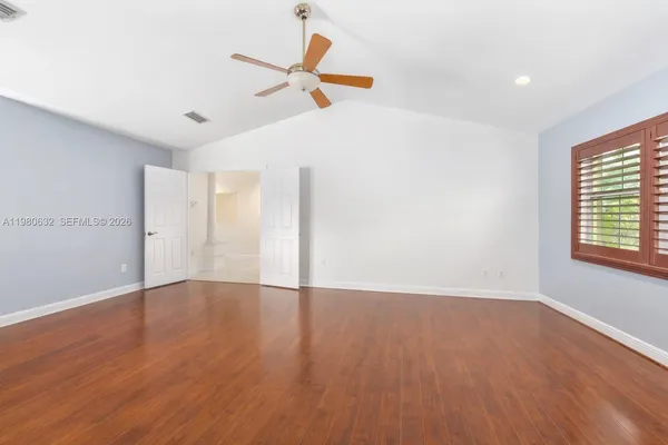 a view of a livingroom with a ceiling fan and window