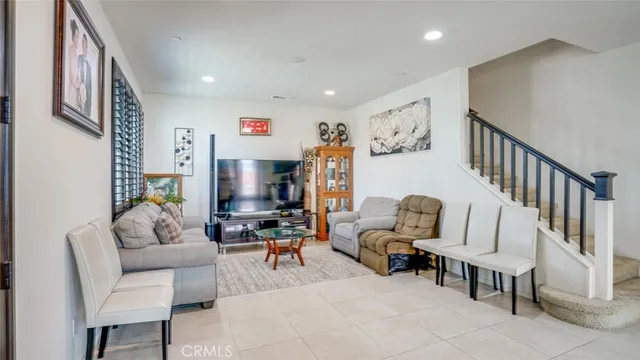 a living room with furniture flat screen tv and a window