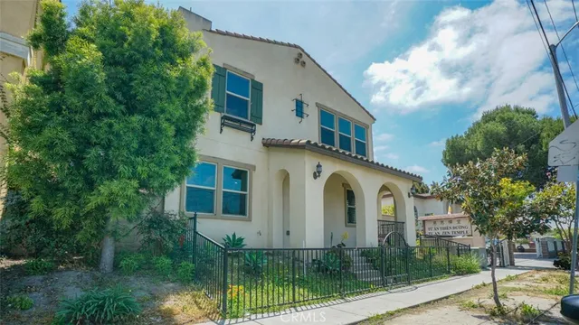 a front view of a white house with a yard