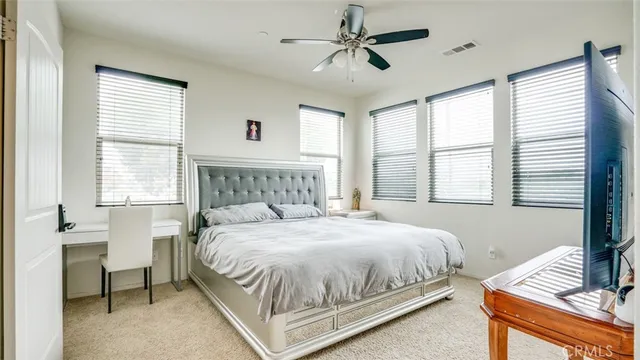 a bedroom with a large bed and a chandelier