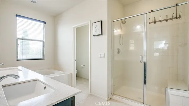 a bedroom with a bed and a potted plant