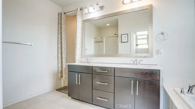 a bathroom with a sink vanity and mirror