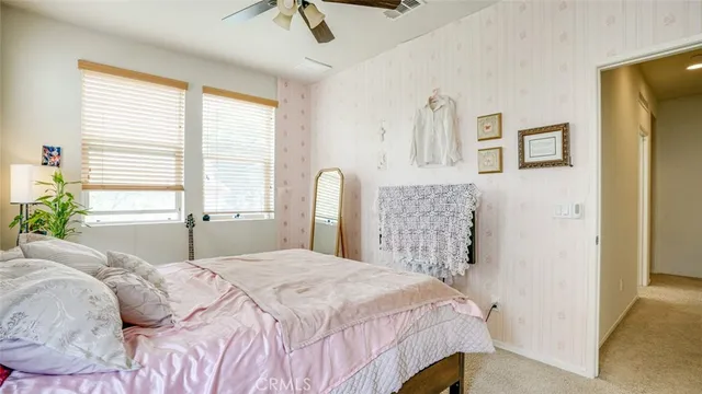 a bed sitting in a bedroom next to a window